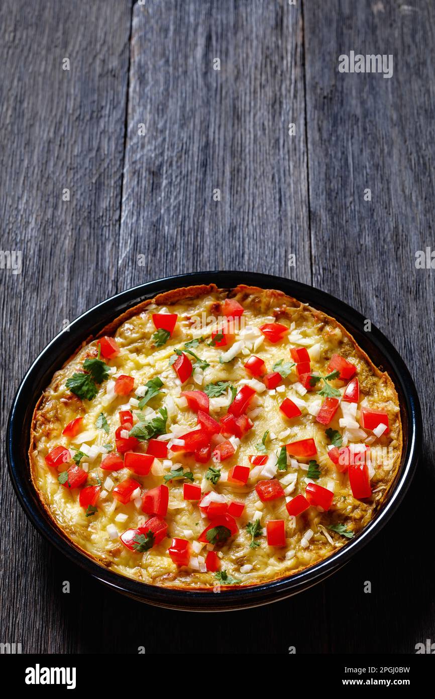 Green Chile Enchilada Casserole of corn tortillas layered with refried