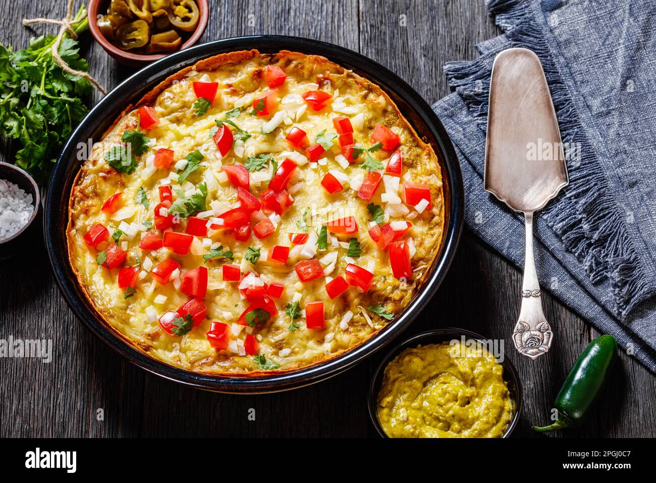 Green Chile Enchilada Casserole of corn tortillas layered with refried