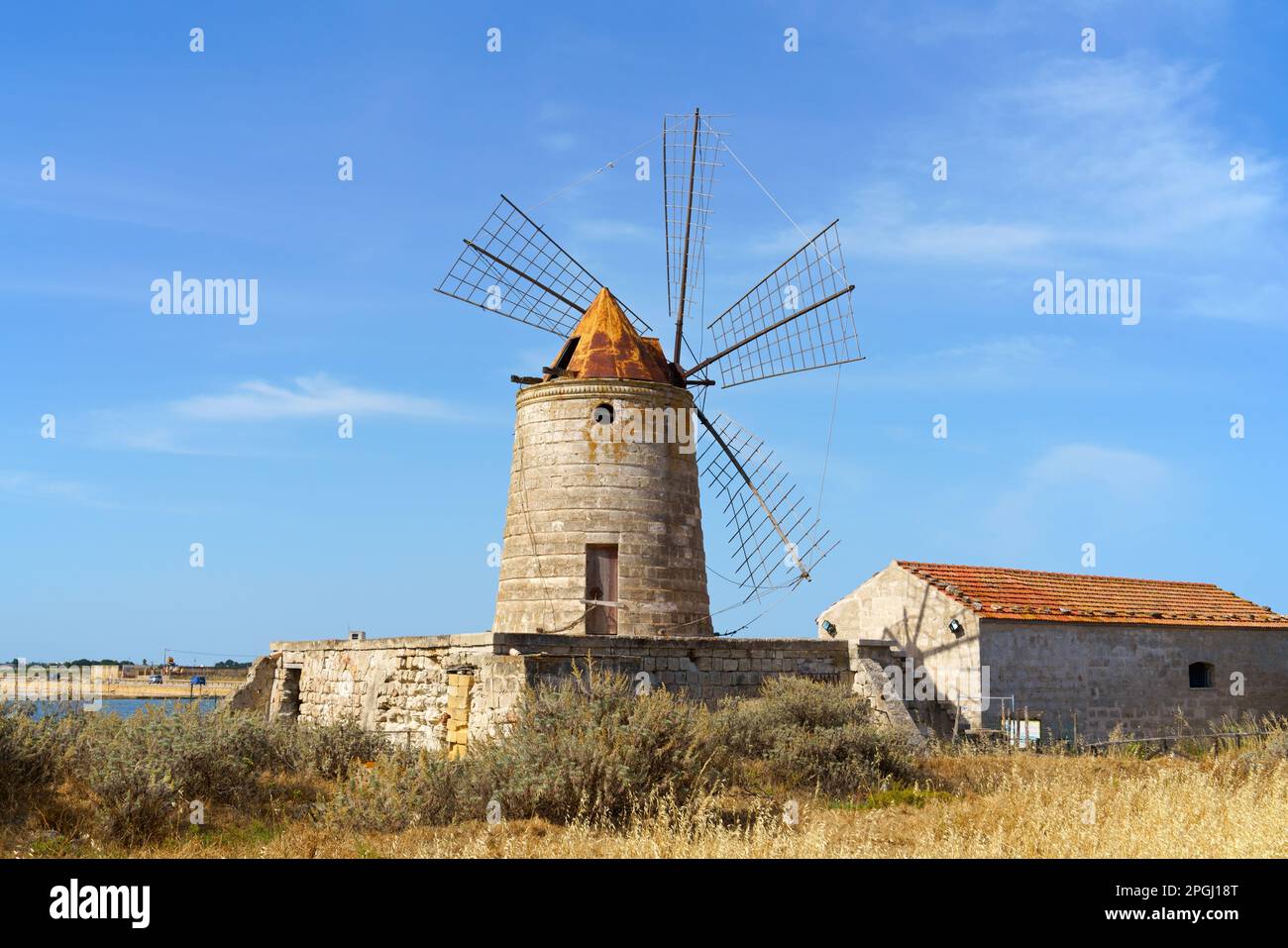 One ancient windmill by the visitors centre in the salt pans of Trapani in Sicily, Italy Stock Photo