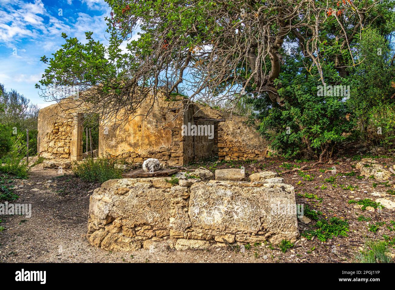Remains of ancient settlements with ruined buildings and wells for drawing water. Vendicari nature reserve, Noto, Syracuse province, Sicily, Italy Stock Photo