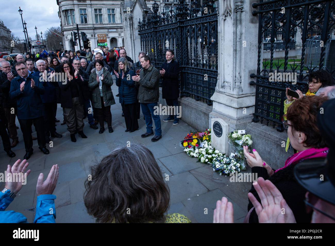 London, UK. 22nd March, 2023. Colleagues gather to pay their respects and lay floral tributes alongside the memorial outside the Palace of Westminster to PC Keith Palmer GM on the sixth anniversary of his death. PC Palmer, 48, died from stab wounds received when thwarting a terrorist attack on the Palace of Westminster by Khalid Masood in March 2017. Credit: Mark Kerrison/Alamy Live News Stock Photo