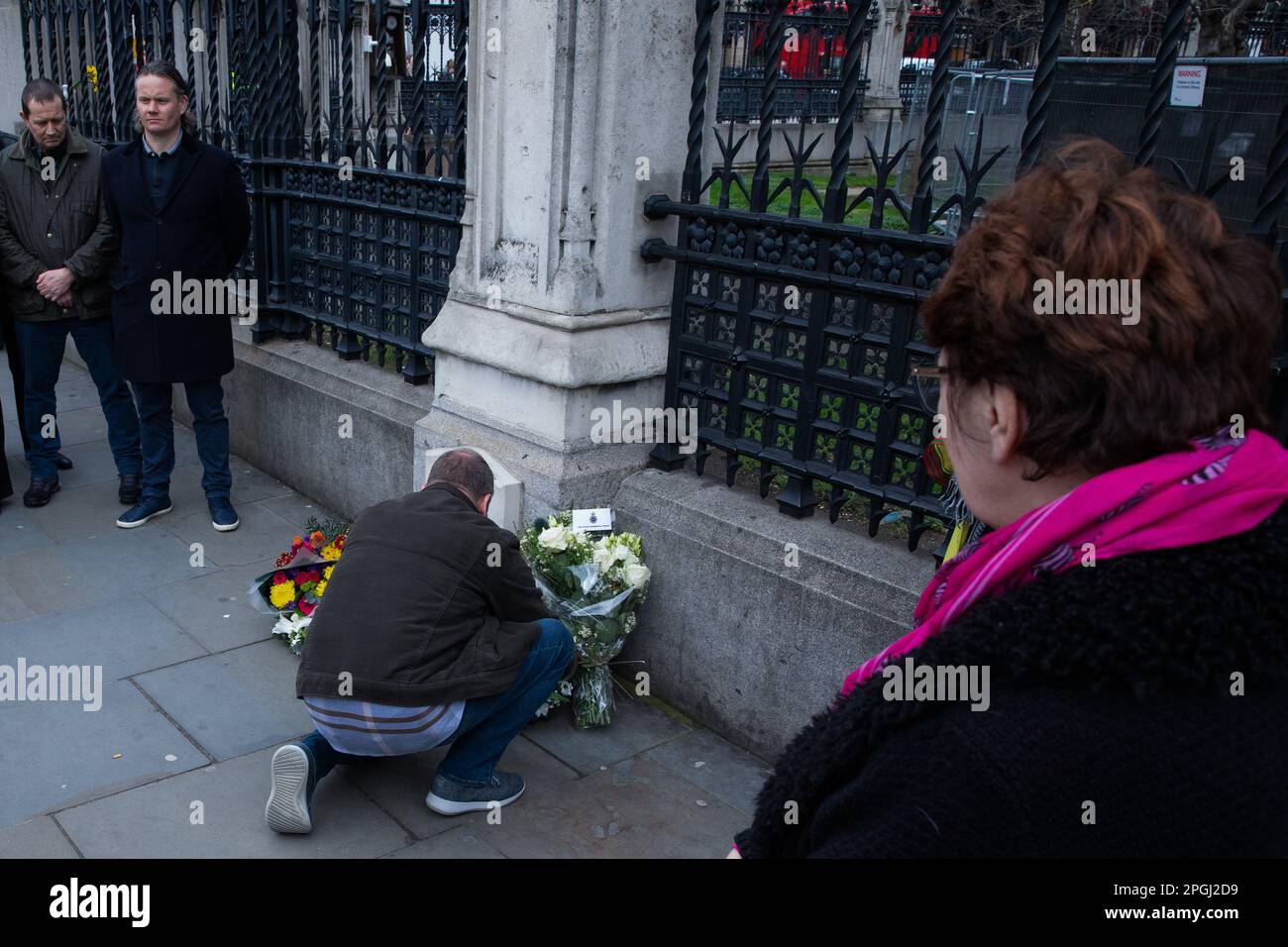 London, UK. 22nd March, 2023. Colleagues gather to pay their respects and lay floral tributes alongside the memorial outside the Palace of Westminster to PC Keith Palmer GM on the sixth anniversary of his death. PC Palmer, 48, died from stab wounds received when thwarting a terrorist attack on the Palace of Westminster by Khalid Masood in March 2017. Credit: Mark Kerrison/Alamy Live News Stock Photo
