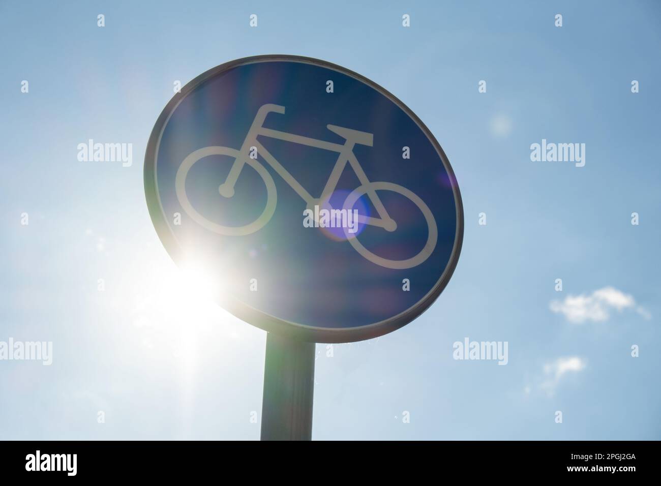 Round road sign depicting white bicycle on blue background, meaning