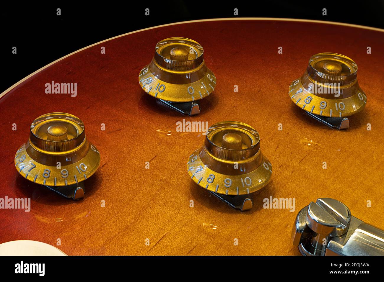 A closeup image of four knobs on a guitar Stock Photo Alamy