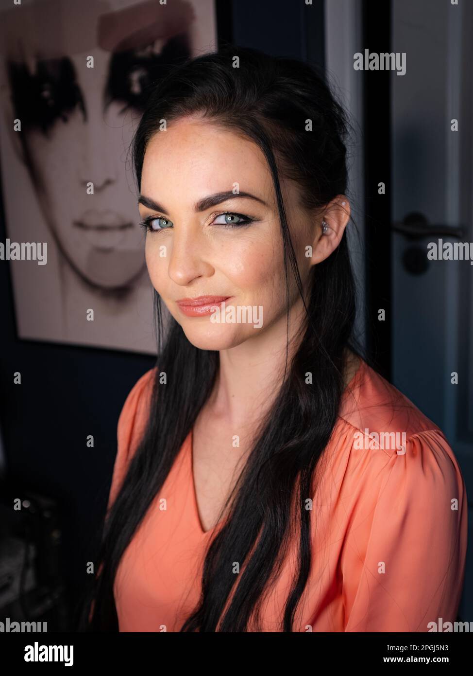 A dark-haired brunette on a Vintage White Chair Stock Photo