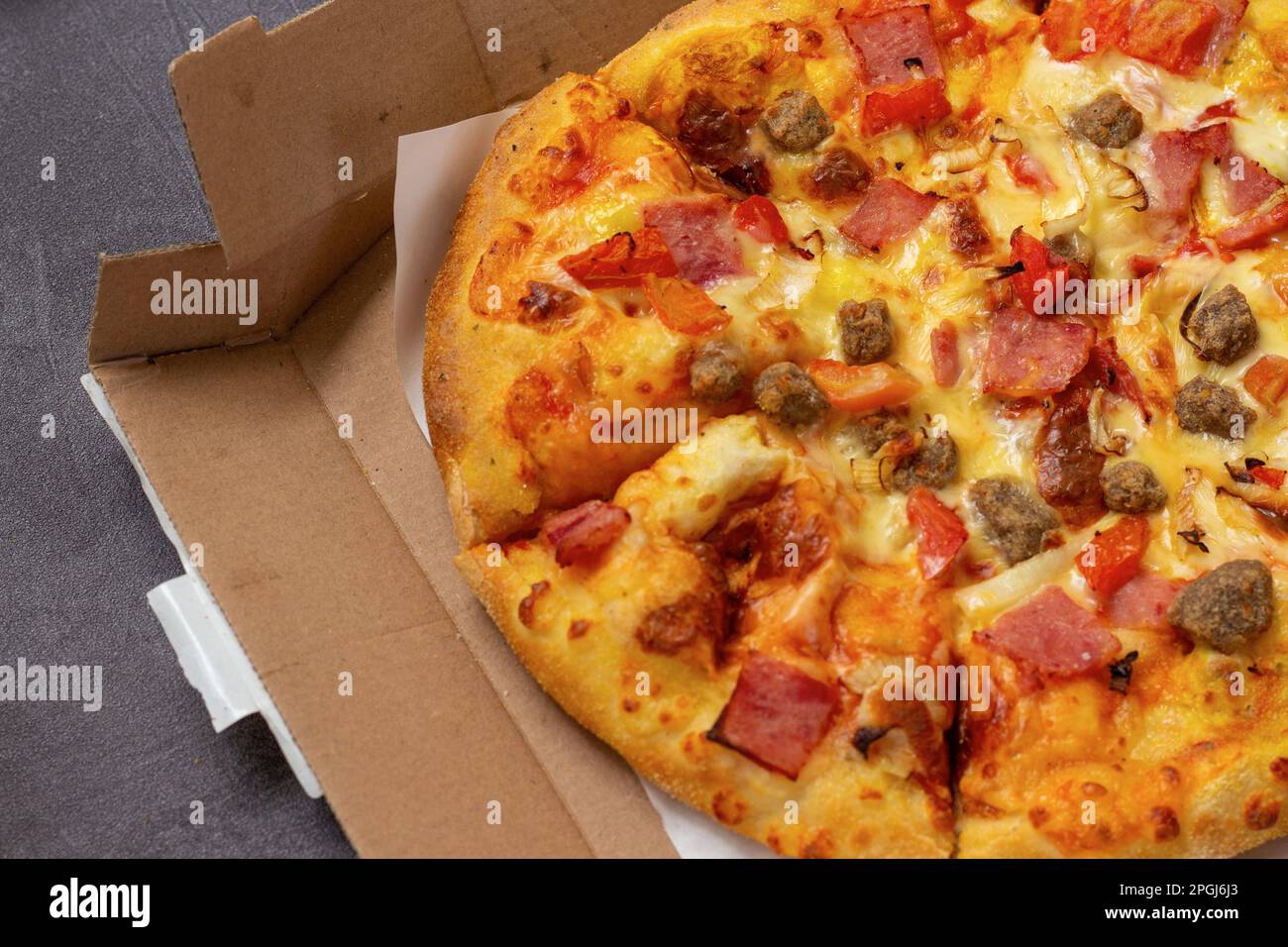 close-up of delicious pizza still in cardboard box Stock Photo