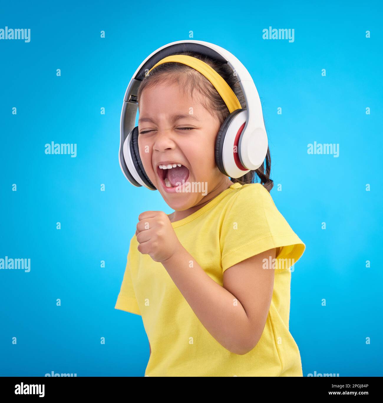 Music, headphones and singing with girl in studio for streaming, mobile radio and audio. Technology, media and youth with child listening isolated on Stock Photo