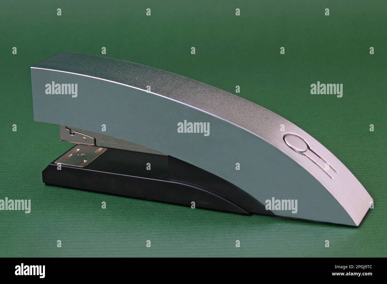 stapler on green background Stock Photo - Alamy