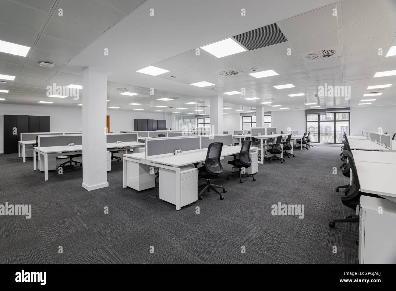Empty gray office with tables and chairs before the start of the working day in the office