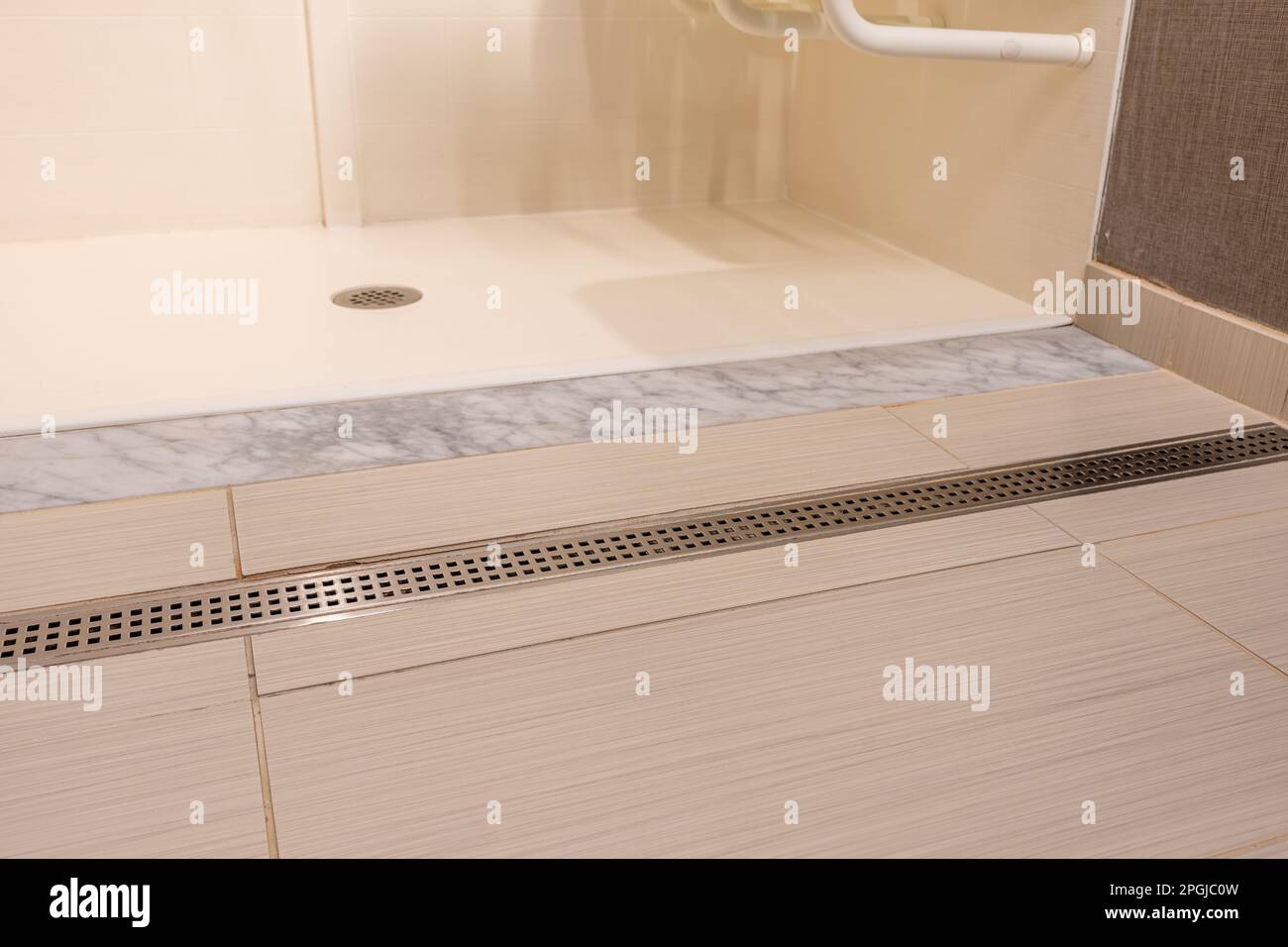 Wheelchair accessible hotel bathroom shower with tile floor and walls Stock Photo Alamy