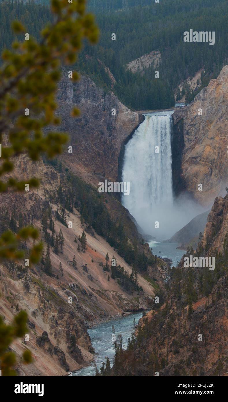 A majestic waterfall cascading through a lush valley surrounded by ...