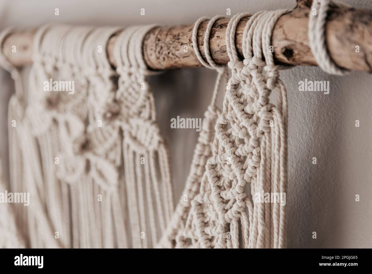 A closeup of delicate macrame hangings isolated on white background Stock Photo