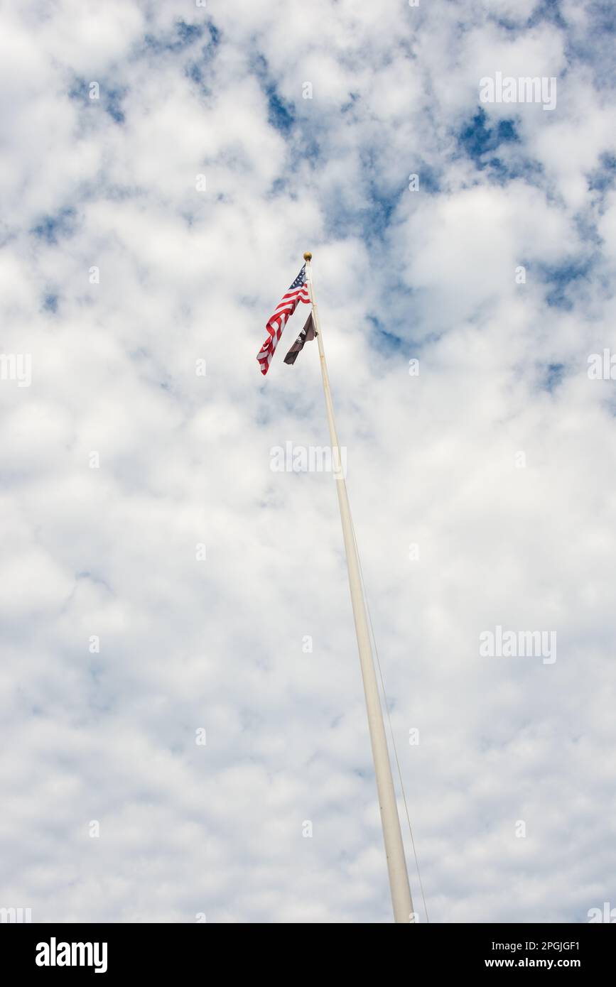 American and POW-MIA Flag Flying High in the Sky Stock Photo