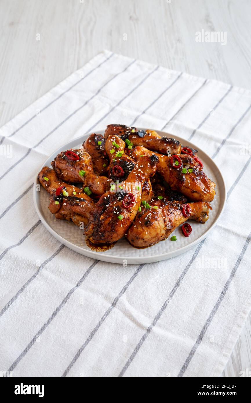 Homemade Easy Sticky Chicken Drumsticks on a Plate, side view Stock