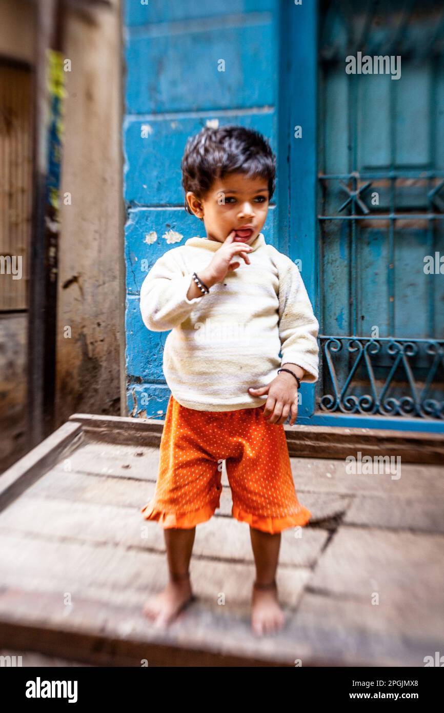 VARANASI, INDIA - OCTOBER 29, 2013: Unidentified beggar child on the street in Varanasi. Poverty is a major issue in India. Stock Photo