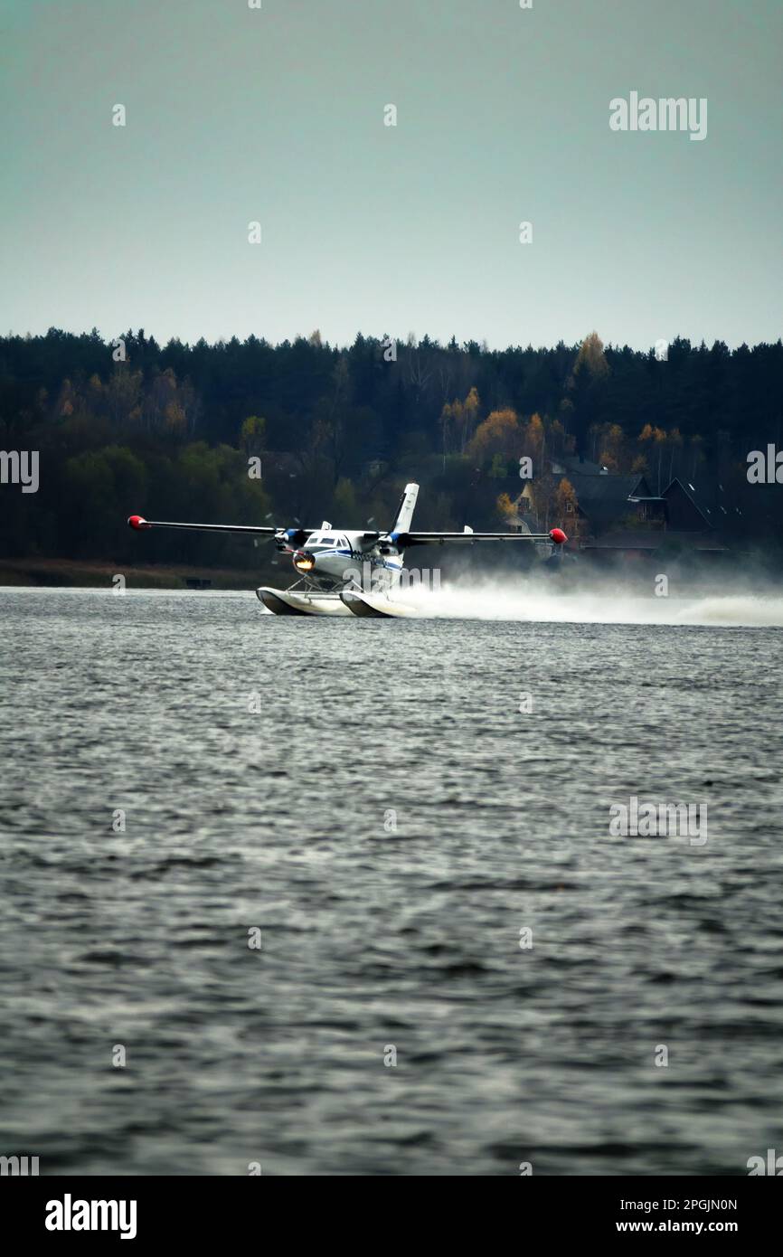 The Twinengine seaplane a seaplane rises from water, from the forest