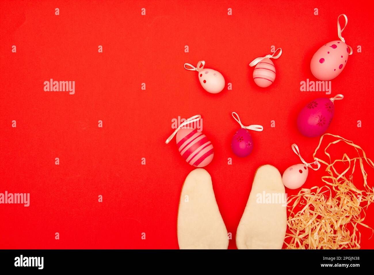 Red backdrop with Easter eggs and bunny ears, plus an area for copying during Easter holidays Stock Photo