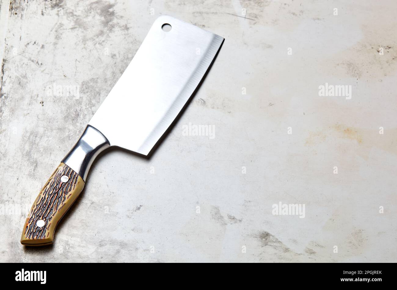 https://c8.alamy.com/comp/2PGJREK/meat-cleaver-on-wooden-background-stainless-steel-kitchen-knife-or-butcher-cleaver-on-a-wood-blackboard-2PGJREK.jpg