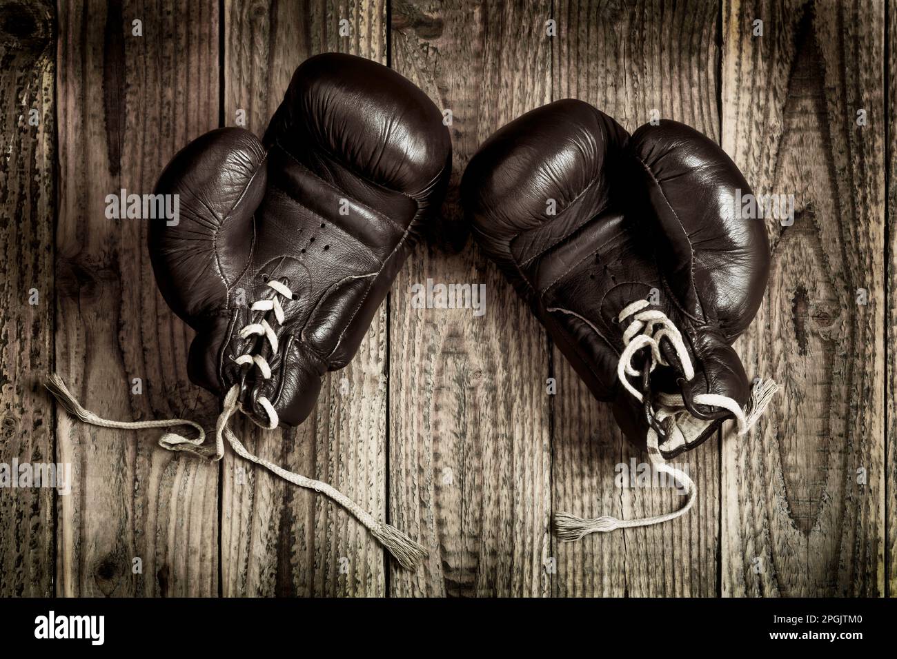 old boxing gloves on wooden background Stock Photo