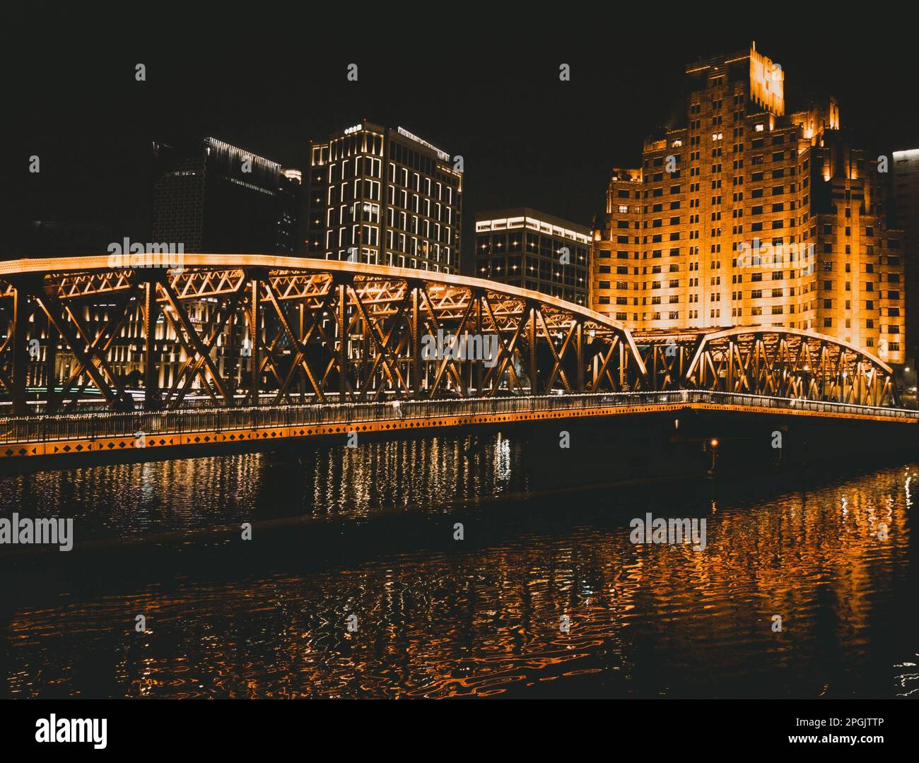 A stunning night view of a brightly lit city bridge extending over a ...