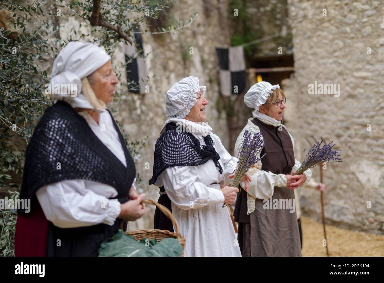 Participants of historical reenactment in the old town of Taggia, Liguria region of Italy Stock Photo