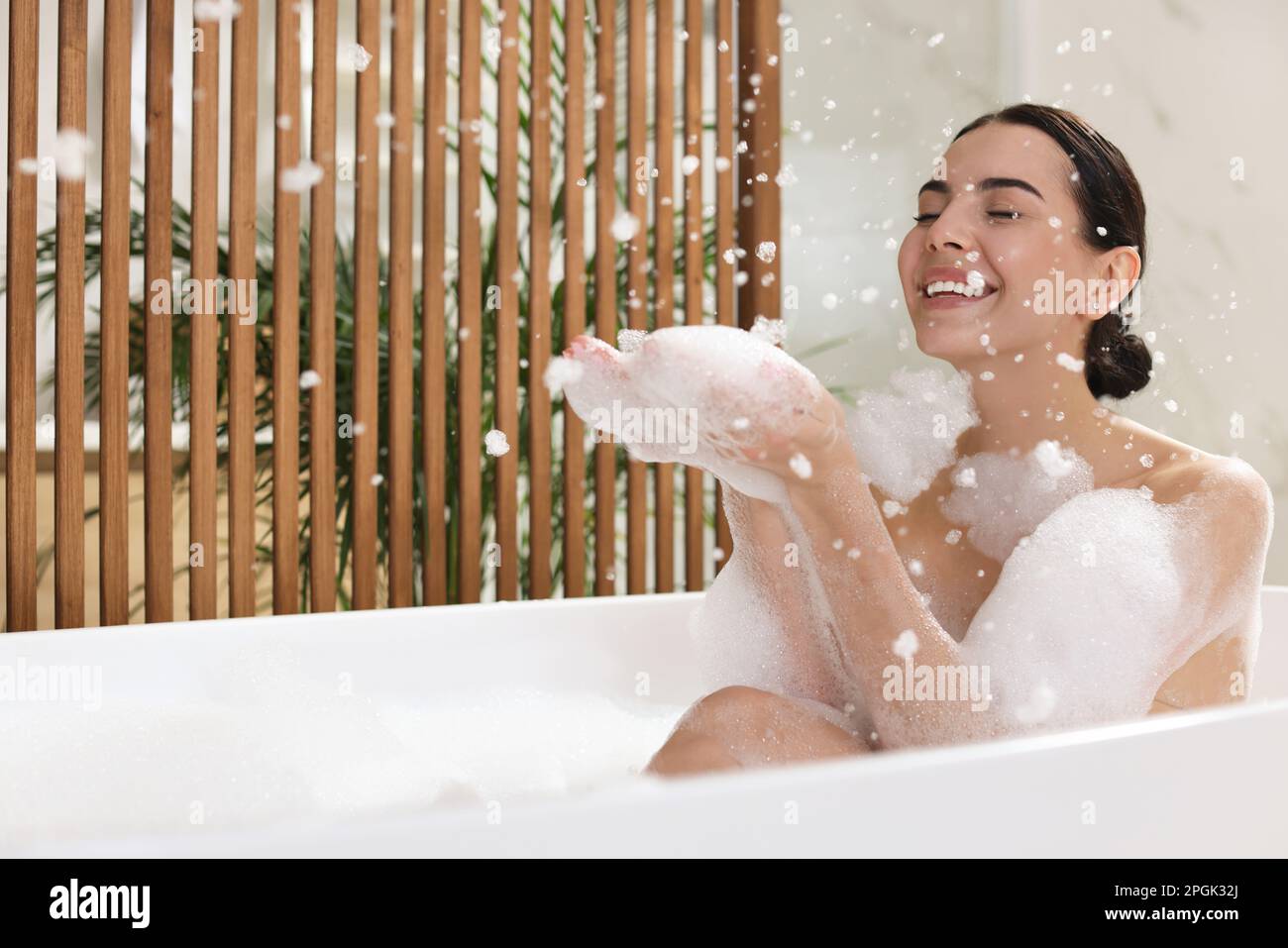 Beautiful young woman taking bubble bath at home Stock Photo Alamy