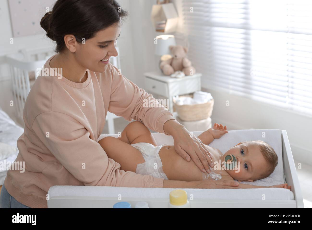 Mother applying dusting powder on her cute baby at home Stock Photo Alamy