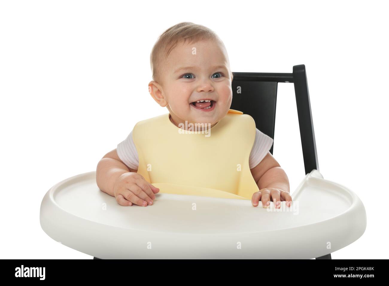 Cute little baby wearing bib in highchair on white background Stock