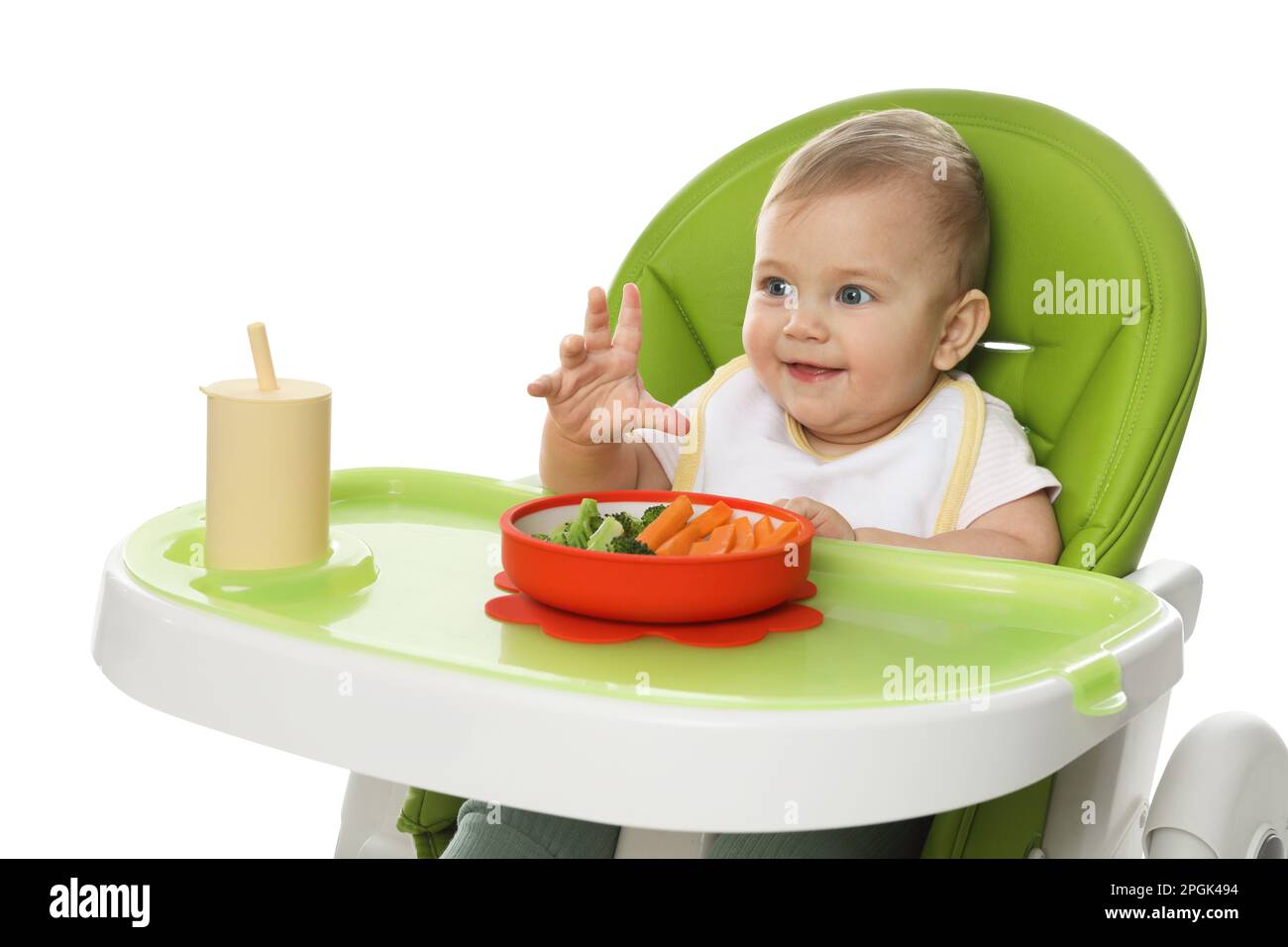 Cute little baby wearing bib while eating on white background Stock ...