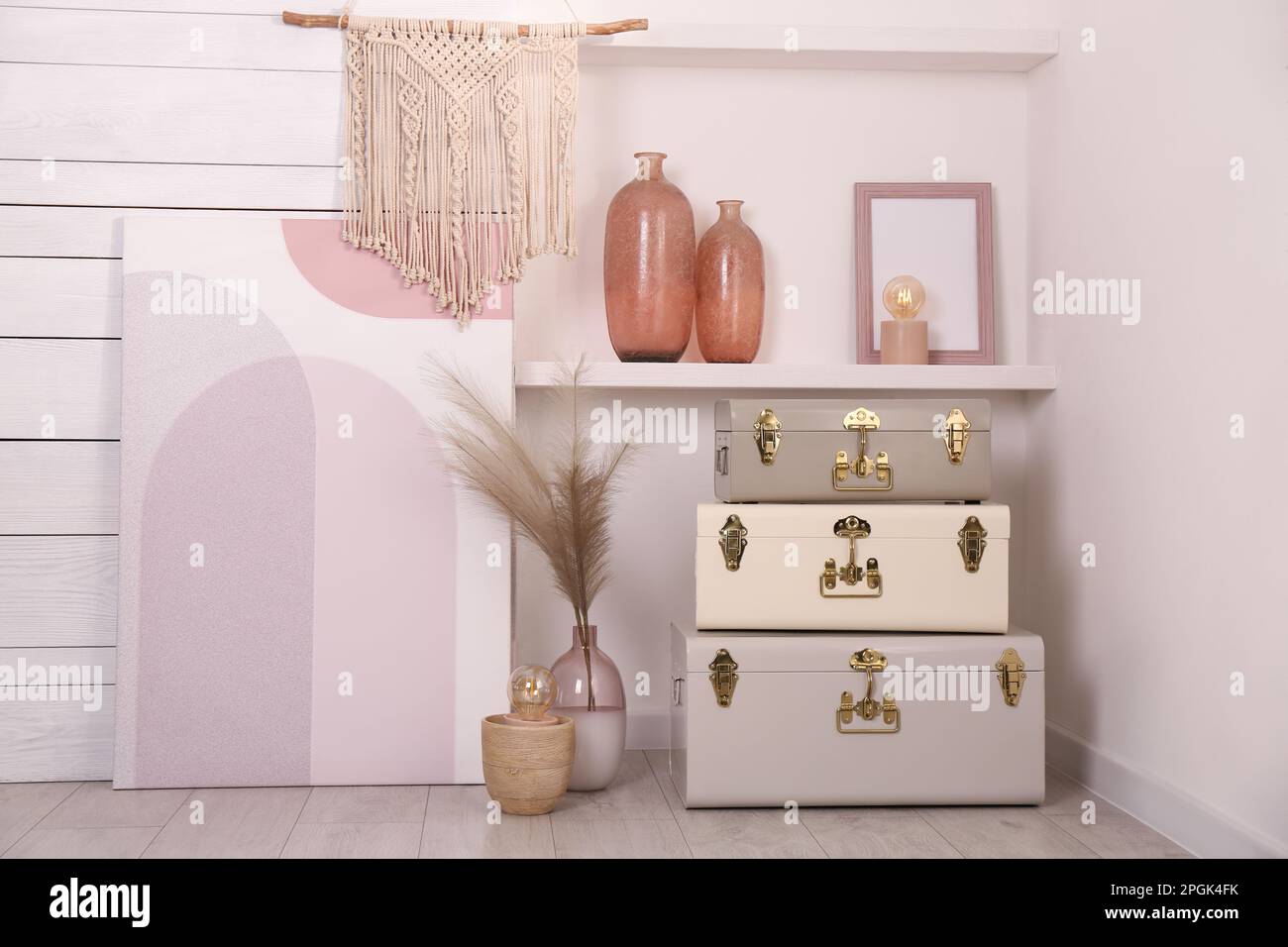 Stylish storage trunks and different decor elements near white wall ...