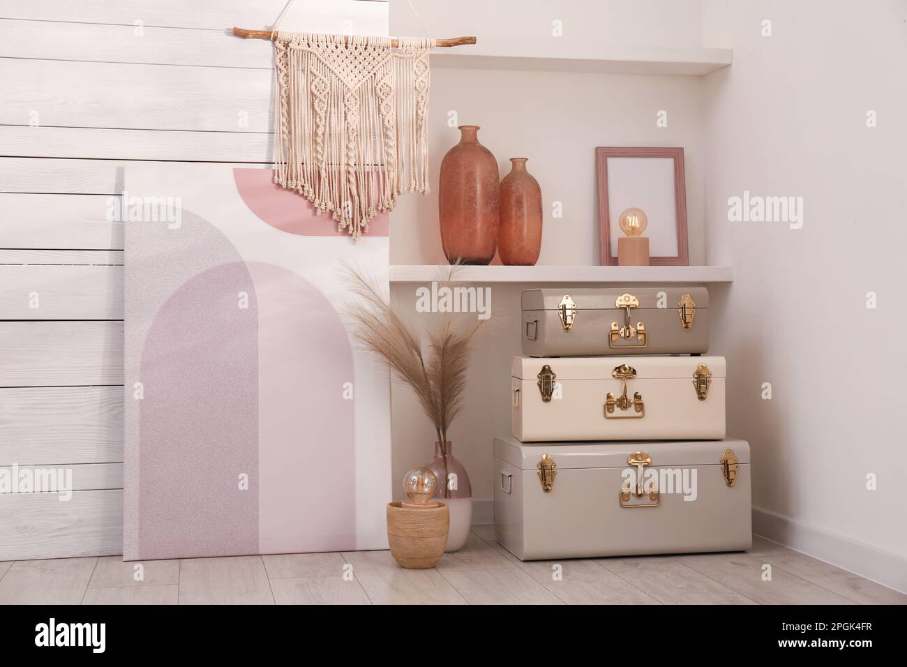 Stylish storage trunks and different decor elements near white wall ...