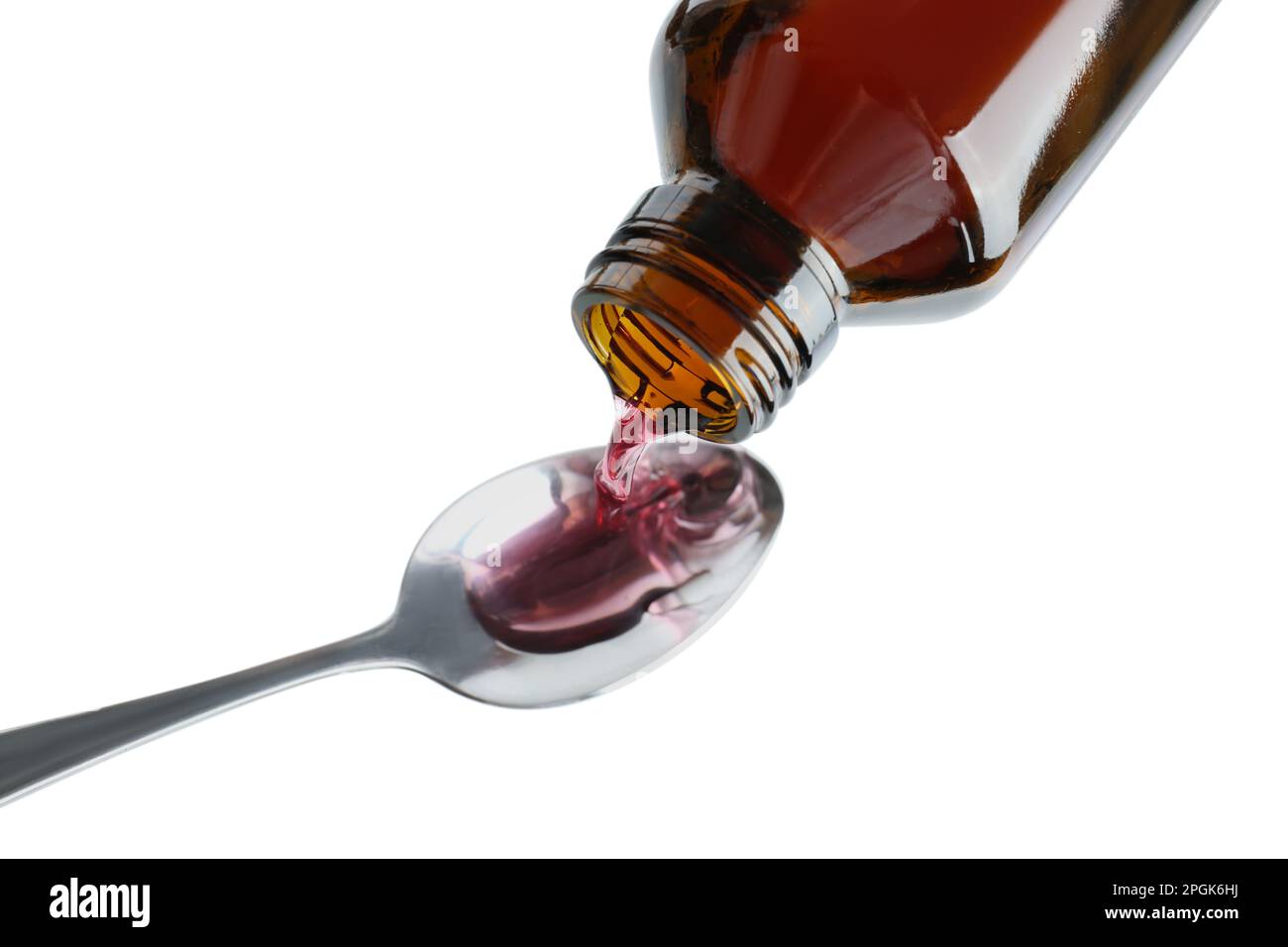 Pouring cough syrup into spoon on white background, above view Stock