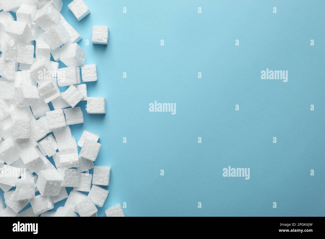 Many styrofoam cubes on light blue background, flat lay. Space for text Stock Photo