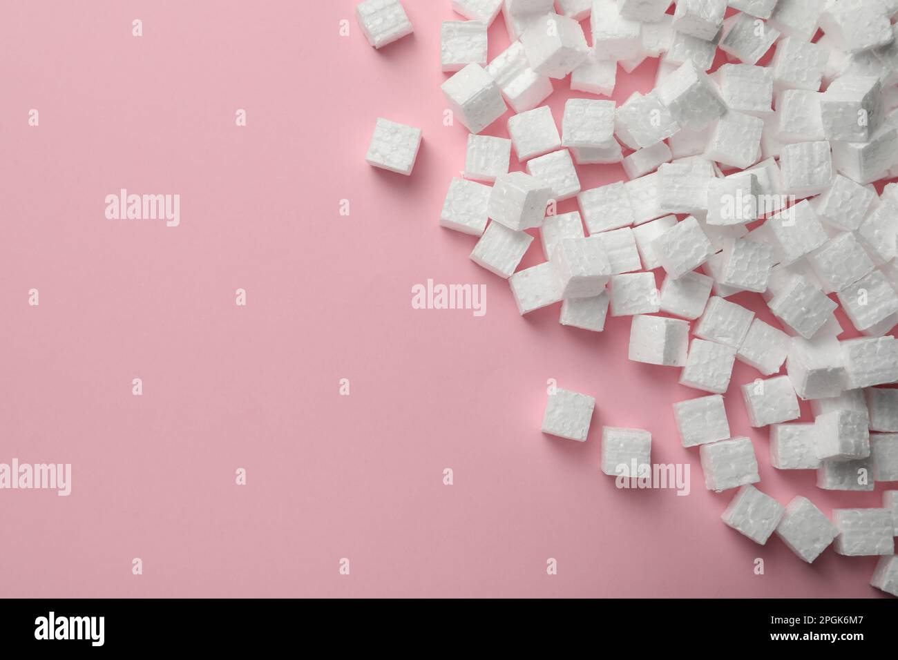 Many styrofoam cubes on pink background, flat lay. Space for text Stock Photo