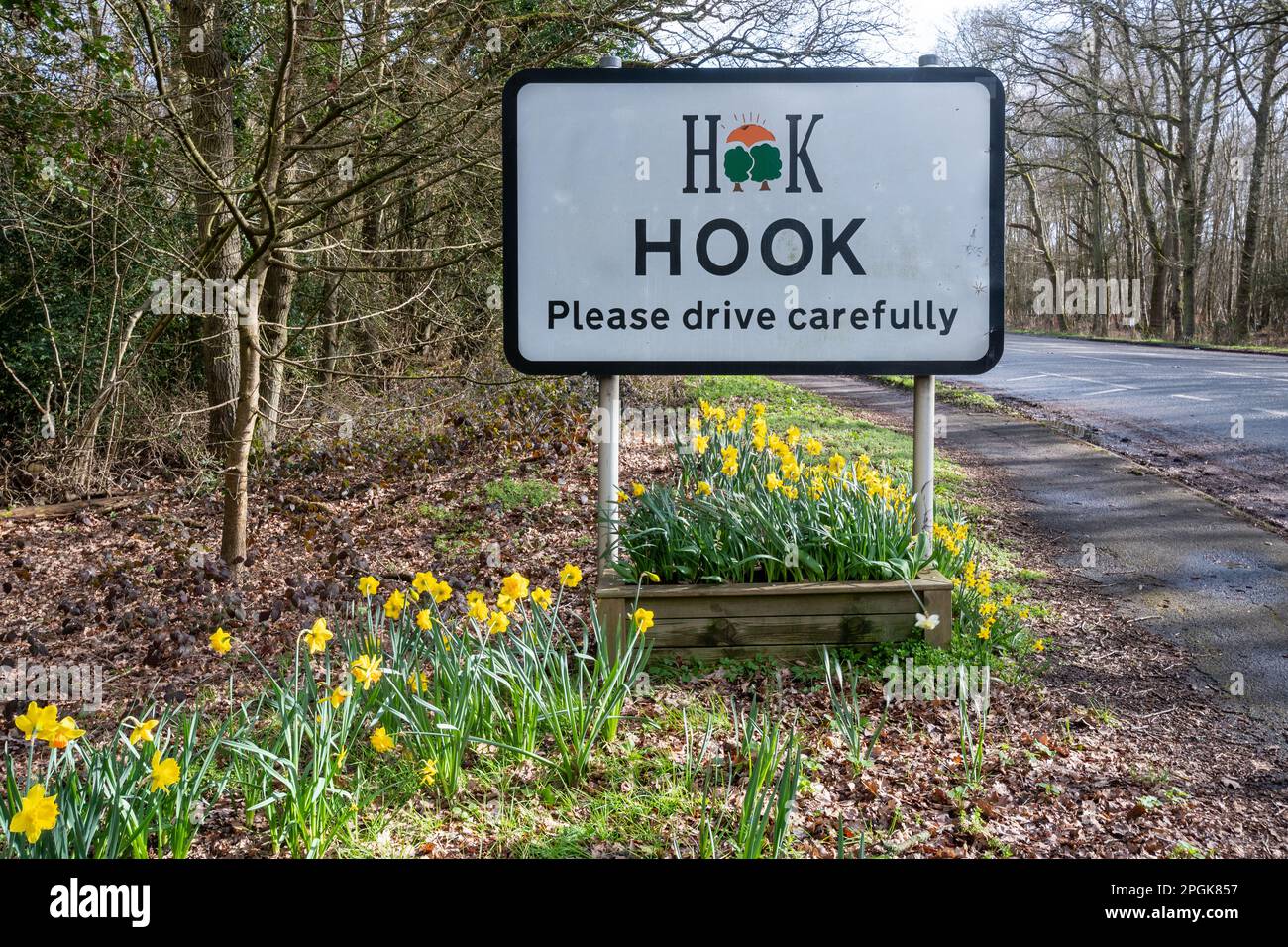 Hook village sign, Hampshire, England, UK, during spring with daffodils