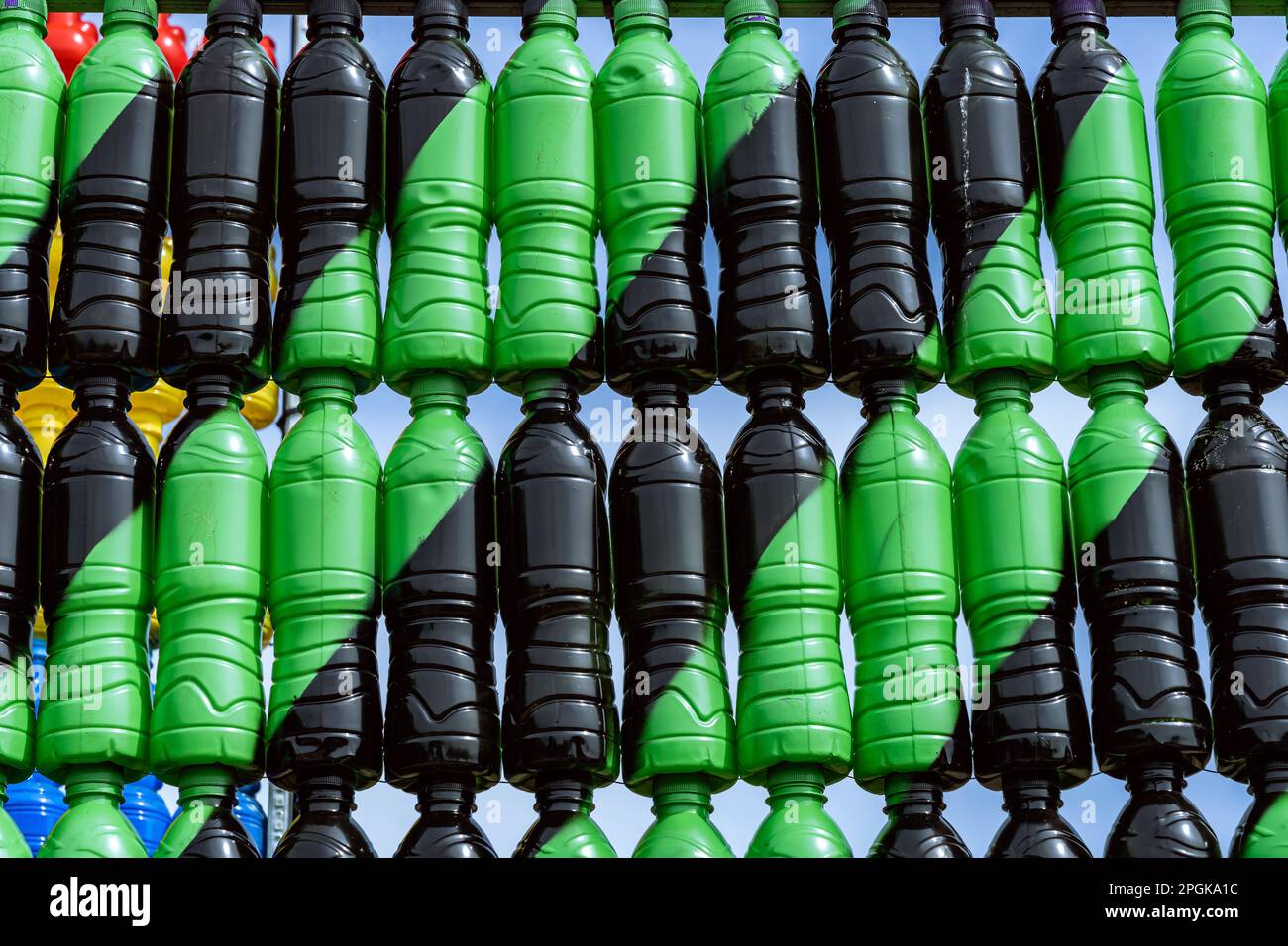 Beautiful wall made of multi colored recycled plastic bottles. Bottle