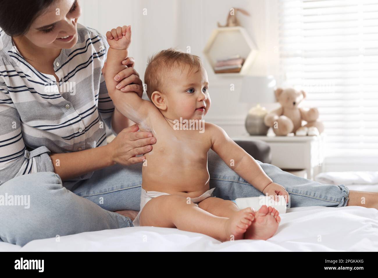 Mother applying dusting powder on her cute baby at home Stock Photo - Alamy