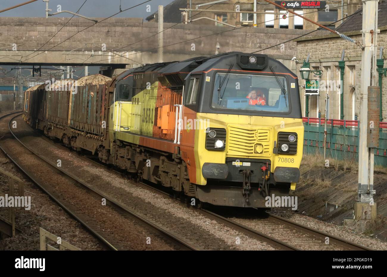 General Electric Powerhaul class 70 diesel-electric loco 70808 in Colas Rail Freight orange and yellow livery on WCML at Carnforth, 22nd March 2023. Stock Photo