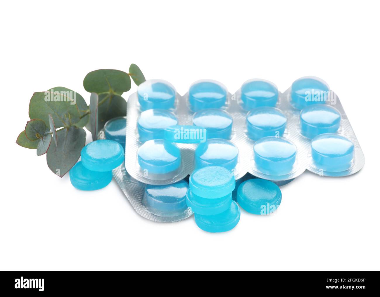 Many light blue cough drops and eucalyptus on white background Stock