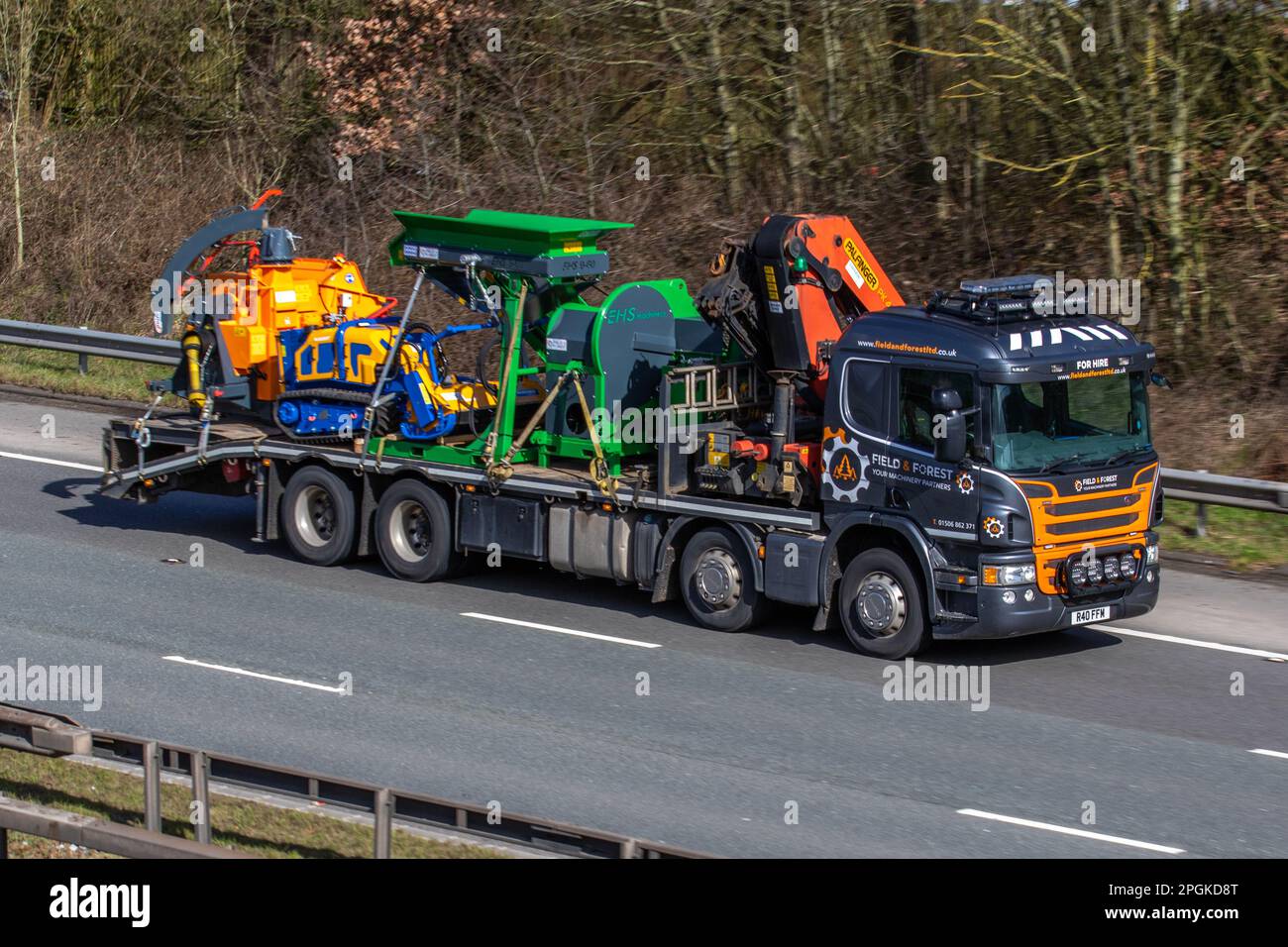 Fields & Forests, agricultural, horticultural, & forestry business. Gardening heavy duty machinery, PALFINGER HIAB Lorry Crane, JENSEN FLAIL BOT, Excavator Mulcher Jansen BM-120, Hydraulic, Mini Excavator, Flail Mower. EHS wood chipper machine; travelling on the M6 motorway UK Stock Photo