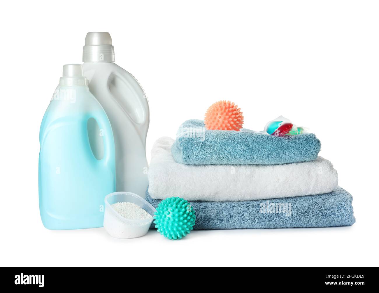Color dryer balls, detergents and stacked clean towels on white