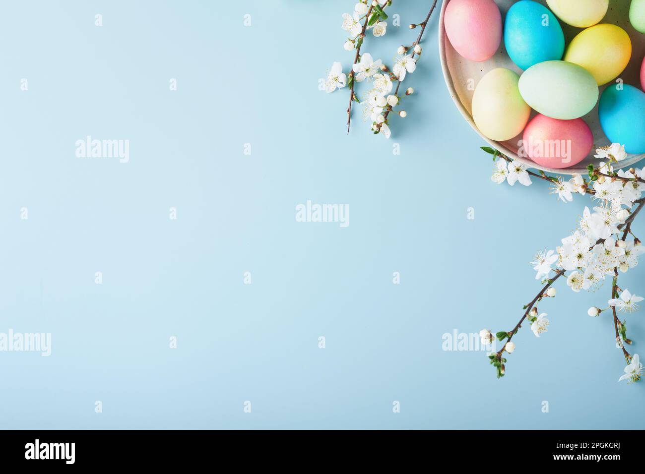 Happy Easter. Dyed Easter eggs on rustic table with cherry blossom tree ...