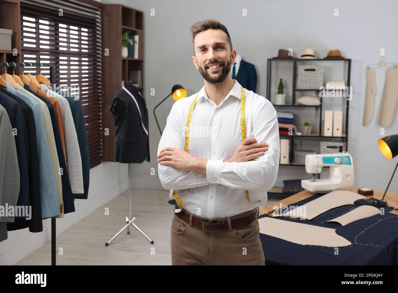 Smiling fashion designer measuring suit hi-res stock photography and ...