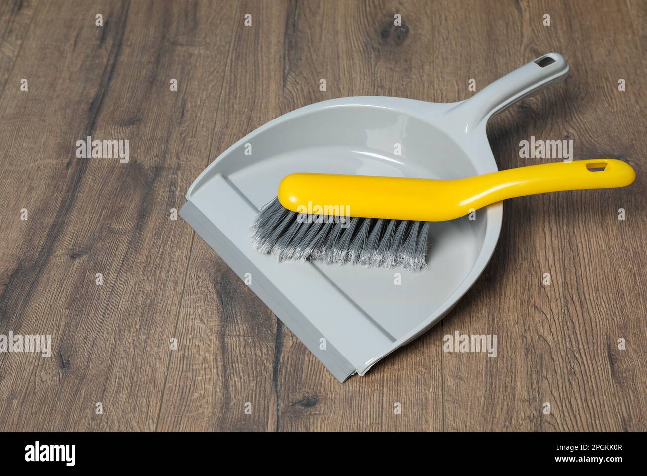 Plastic whisk broom with dustpan on wooden floor Stock Photo Alamy