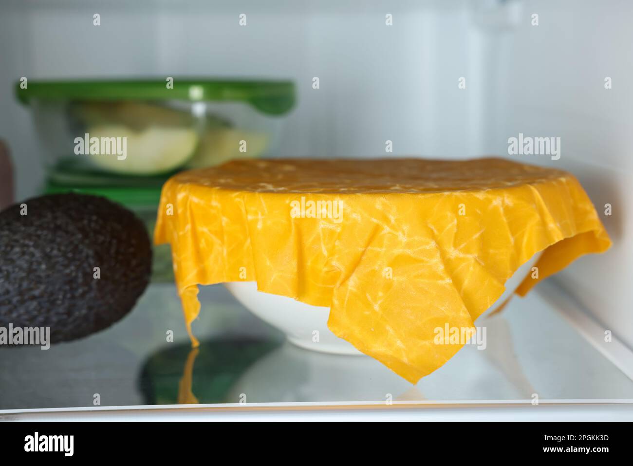 Products packed with beeswax food wrap on refrigerator shelf, closeup Stock Photo