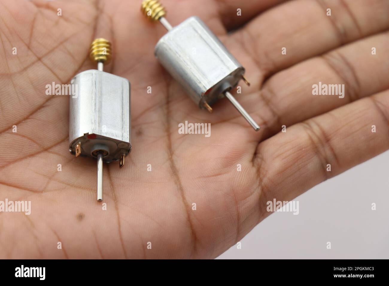 Double shaft dc motors held in hand with metal gear attached to its