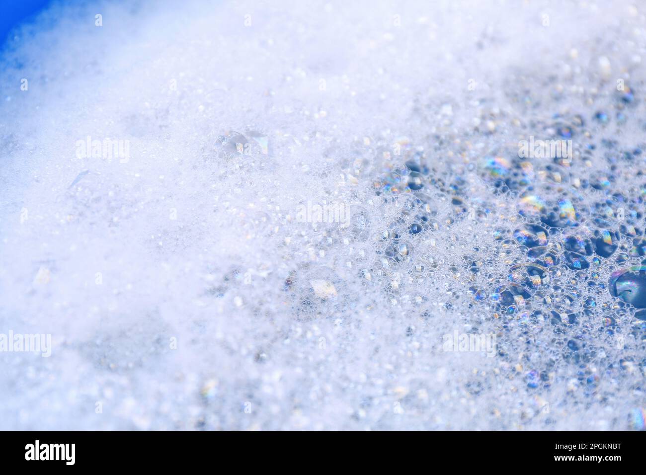 Detergent foam as background, closeup. Hand washing laundry Stock Photo