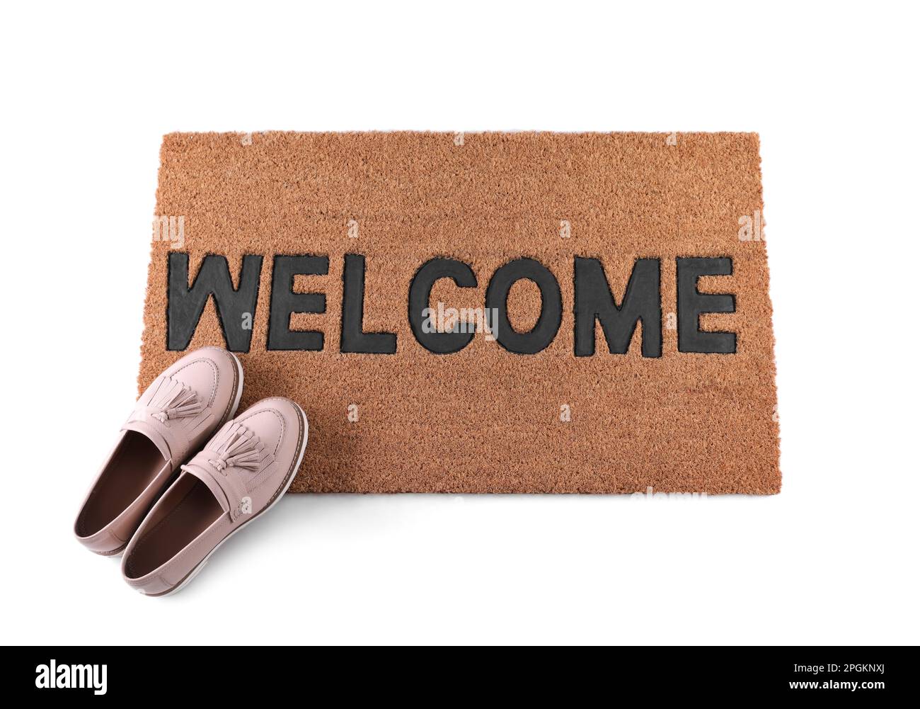 Stylish door mat with word and female shoes on white background