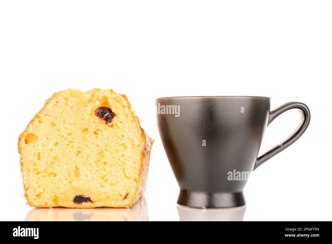 One slice of aromatic homemade raisin cupcake with black ceramic cup ...