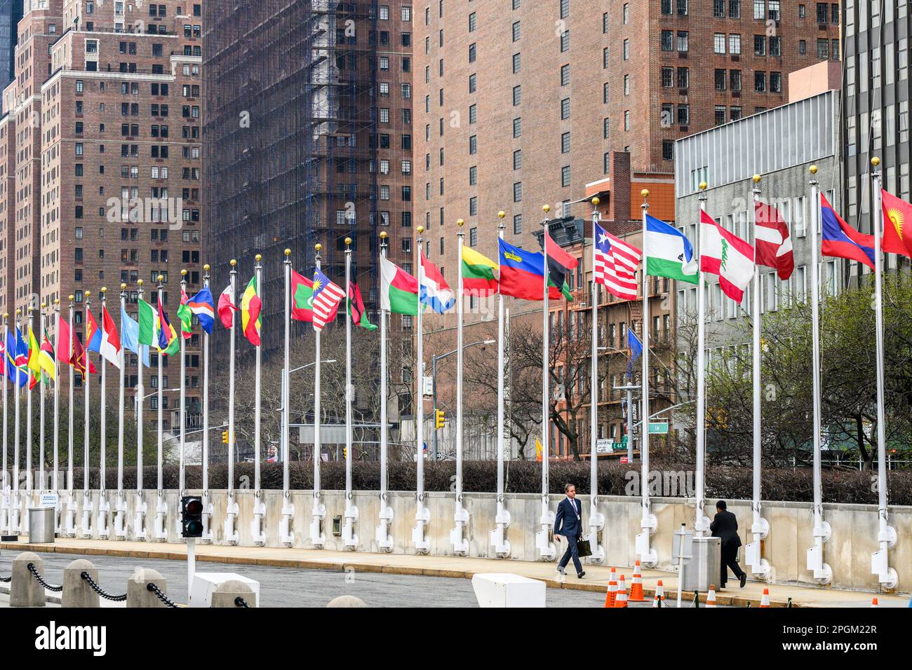 New York, USA. 23rd Mar, 2023. Delegates walk past national flags at ...